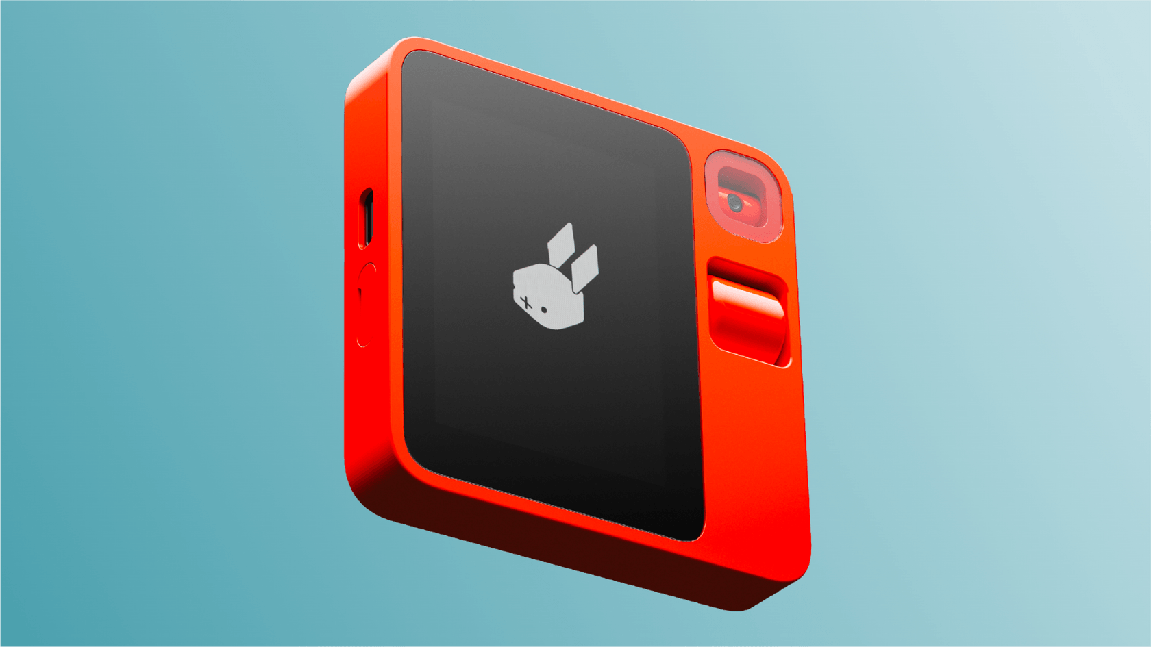 A close-up of the Rabbit AI R1, a small, square, orange AI-powered gadget.