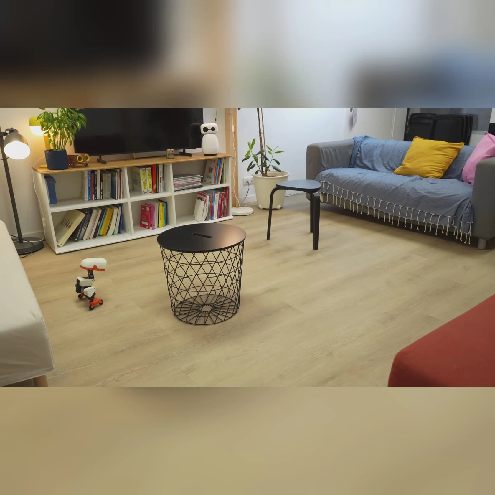 A Microduck roller-skating across a living-room floor on the Accessory Pack rollers, as taken from Pollen Robotics