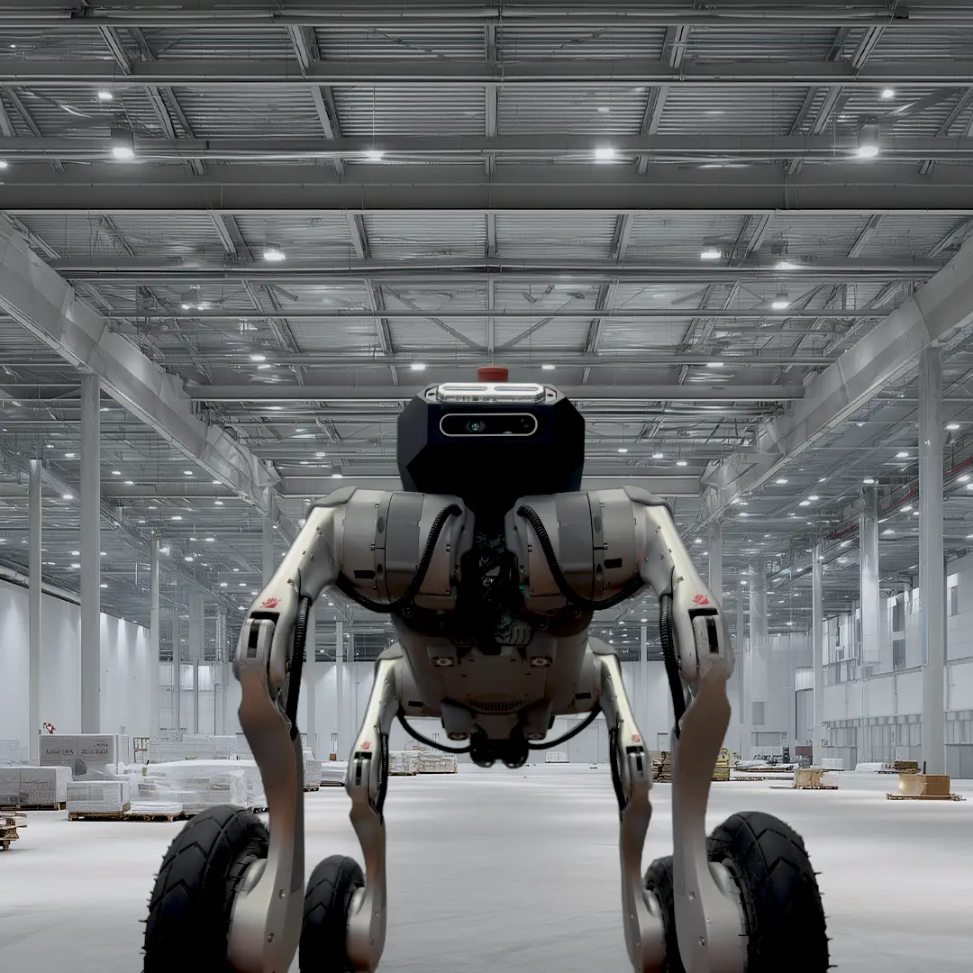 A Skild wheeled-legged robot navigating a large warehouse for inspection work