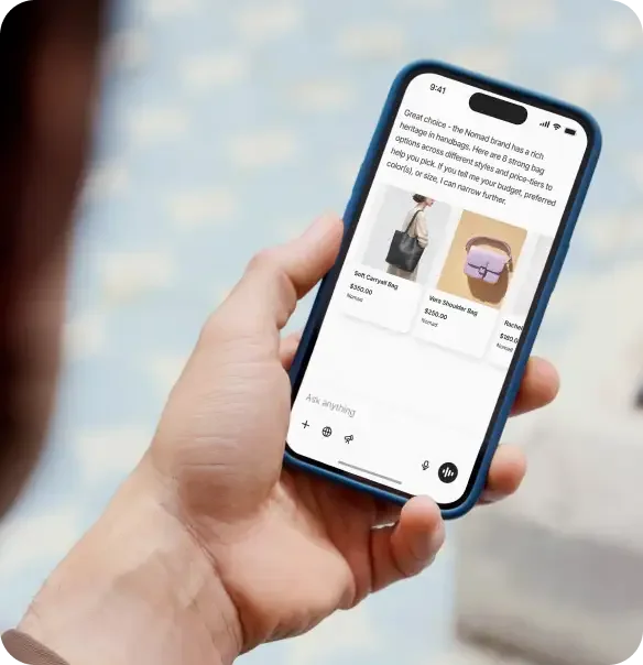 A shopper browsing products and comparing prices inside an AI chat on their phone, as taken from Shopify