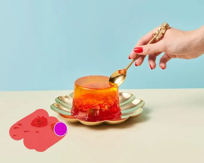 Picsart's remove brush painted in red over a spill beside a jelly dessert, with the magenta brush cursor visible, as taken from Picsart
