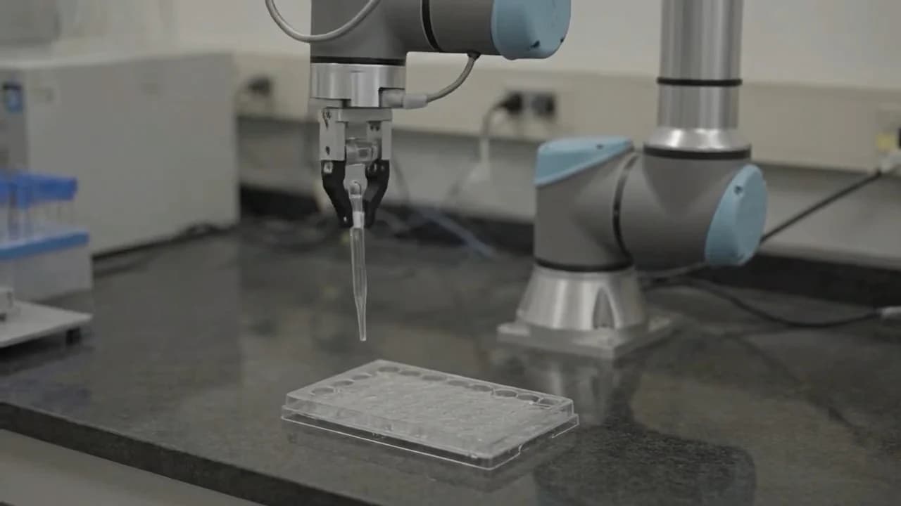Genie 4 simulation of a robot arm holding a pipette over a lab plate, as taken from Google DeepMind's Genie 4 page